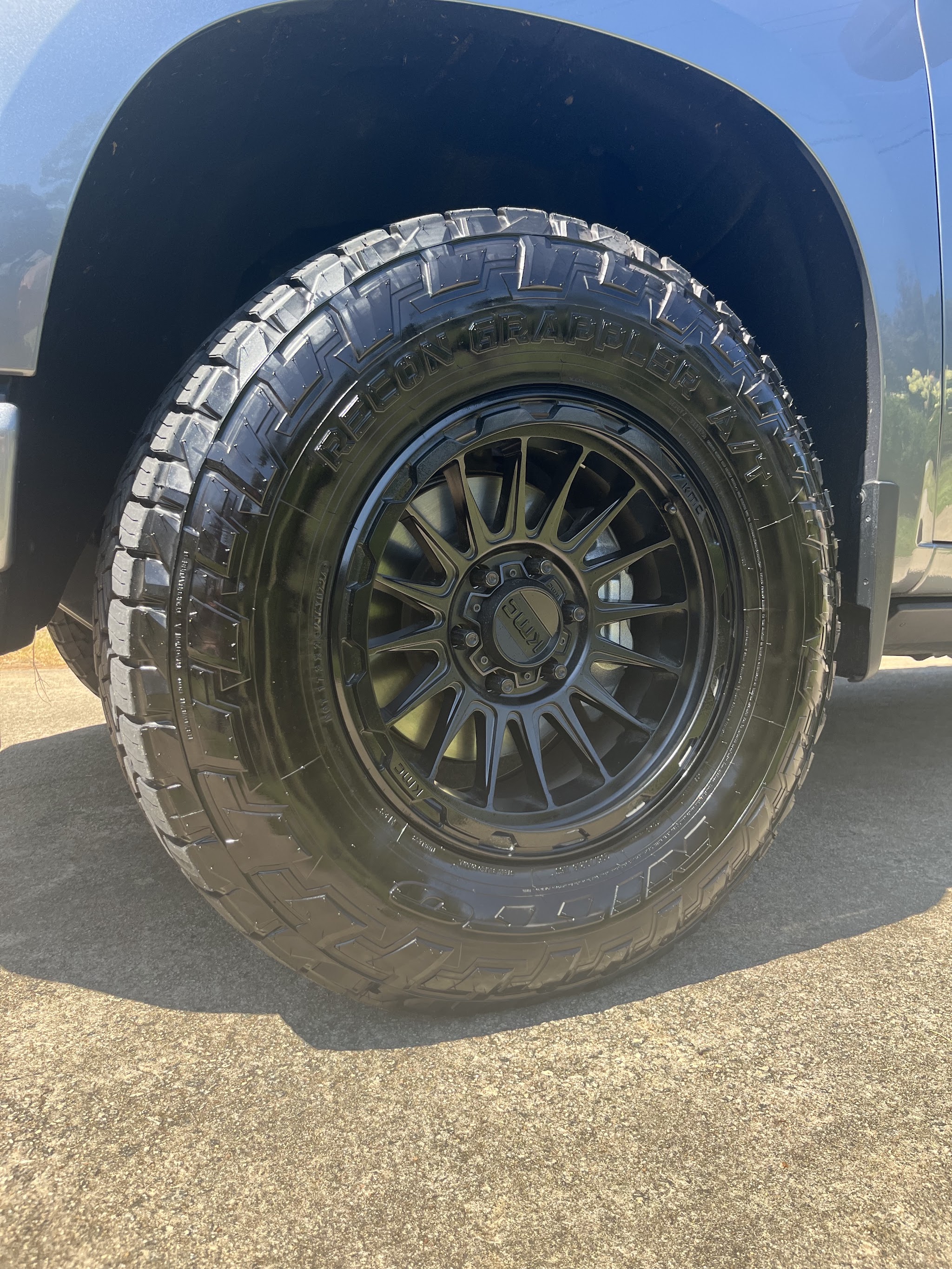 Close-up of a freshly cleaned black wheel and tyre on a pickup